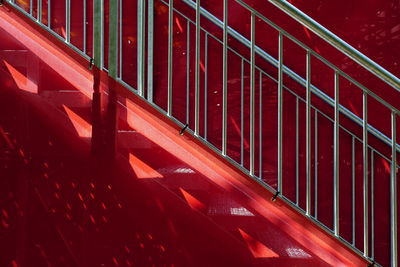 Low angle view of steps against red wall