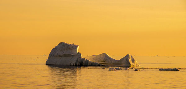 Scenic view of sea against clear sky during sunset