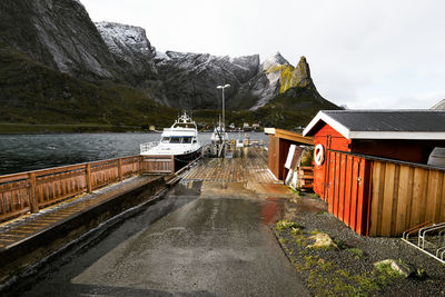 Houses by lake and buildings against sky