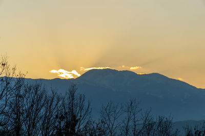 Scenic view of snowcapped mountains against sky during sunset