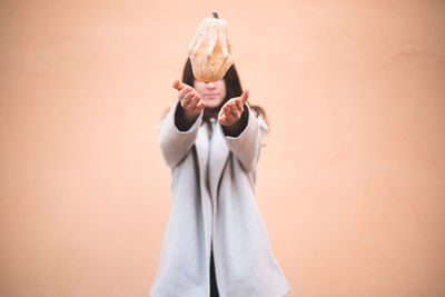 Midsection of woman standing against wall