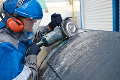 Midsection of man working in factory