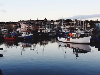 Boats moored at harbor