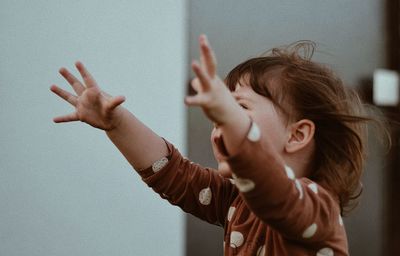 Portrait of girl with arms raised