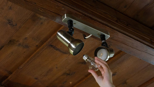 Directly above shot of person holding camera on hardwood floor