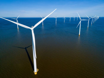 Low angle view of windmill against sky