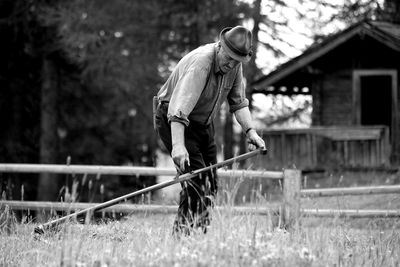 Man holding umbrella on field