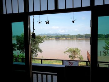 Scenic view of lake seen through window