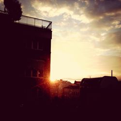 Low angle view of buildings against sky at sunset