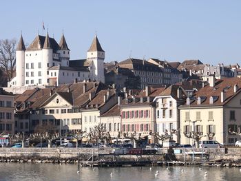 Buildings in city against clear sky