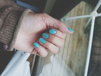 High angle view of woman hand by window