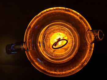 High angle view of beer glass on table against black background