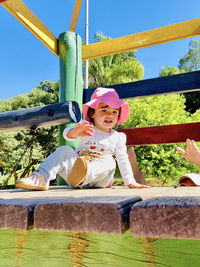 Portrait of smiling girl standing against plants