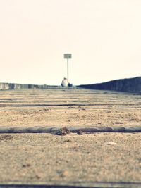 Surface level of road against clear sky