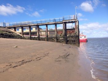 View of beach against cloudy sky