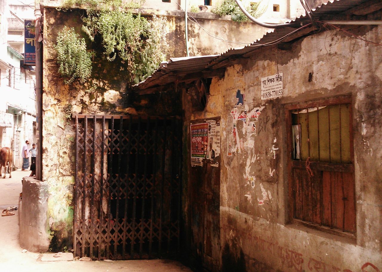 architecture, built structure, building exterior, house, door, abandoned, old, window, obsolete, text, damaged, run-down, weathered, residential structure, entrance, building, deterioration, residential building, wall - building feature, day