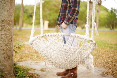 Midsection of man standing in wicker basket