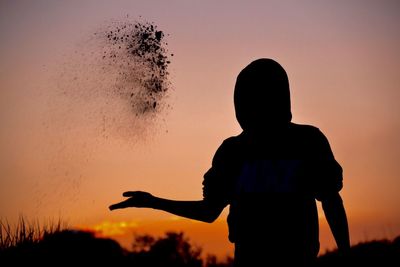 Silhouette of woman at sunset