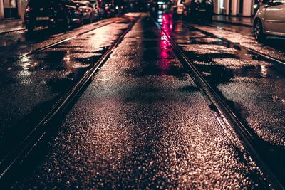 Railroad tracks on wet city street
