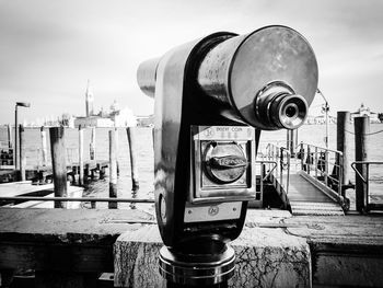 Close-up of coin-operated binoculars against sky