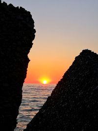 Scenic view of sea against orange sky