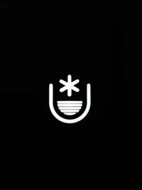 Close-up of illuminated lamp against black background