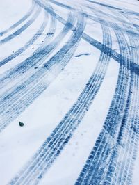 High angle view of tire tracks on snow