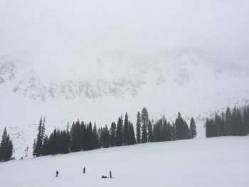 Scenic view of snow covered field against sky