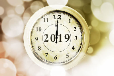 Close-up of clock amidst defocused lights