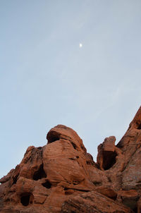 Low angle view of rock formation against sky