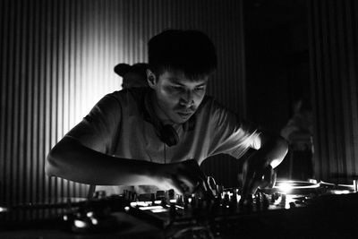 Young man playing music in club