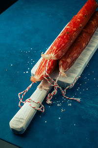 Dry sausage. top view country sausage, homemade sausage with copy space on white wooden rustic board 