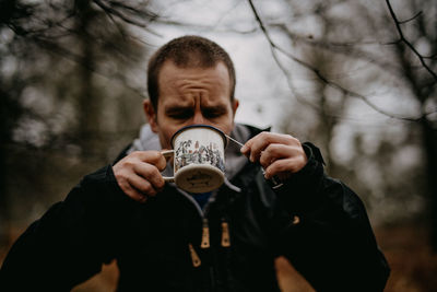 Man drinking coffee in forest