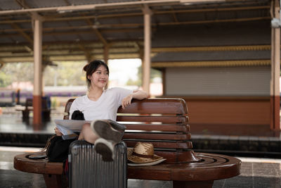 Side view of woman sitting on chair