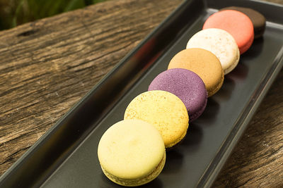 Colorful and delicious french macaron cookies varieties on a wooden table