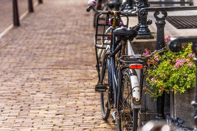 Close-up of bicycle parked on sidewalk in city