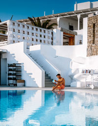 Rear view of woman swimming in pool