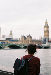 Rear view of woman in city at waterfront