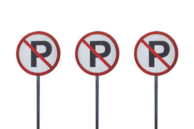 Close-up of road sign against white background