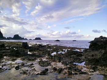 Scenic view of sea against cloudy sky