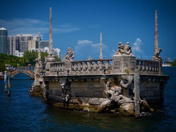 View of bridge over river against cloudy sky