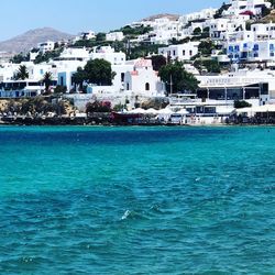 Scenic view of sea by buildings in town