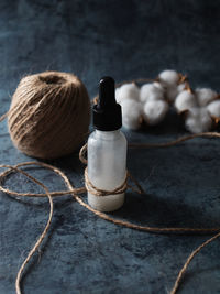 White serum bottle on dark background. homemade skincare product. organic cosmetics. selective focus