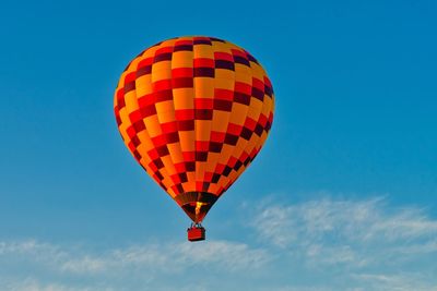 Low angle view of hot air balloon against blue sky