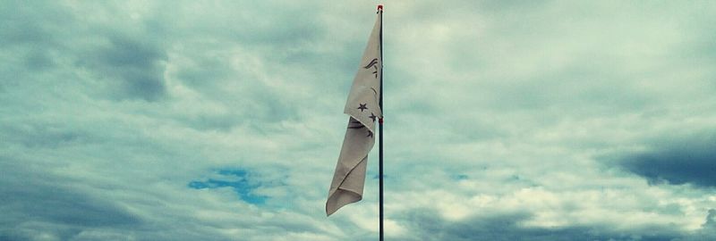 Low angle view of flag against sky