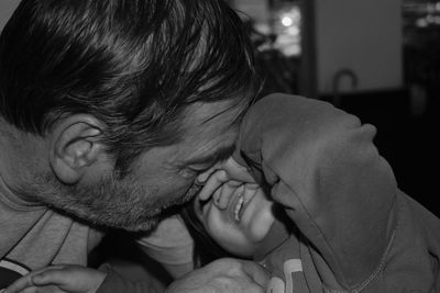 Close-up of playful father and daughter at home