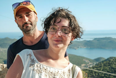 Portrait of friends against sea and sky