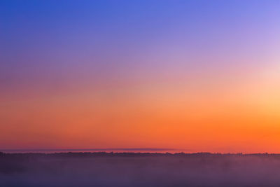 Scenic view of silhouette landscape against romantic sky at sunset