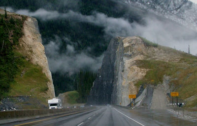 Road amidst mountains against sky