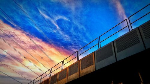 Low angle view of bridge against cloudy sky